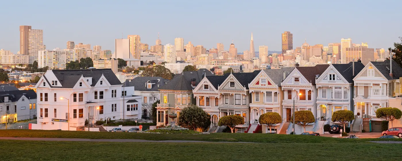 Painted Ladies Victorians with downtown skyline behind