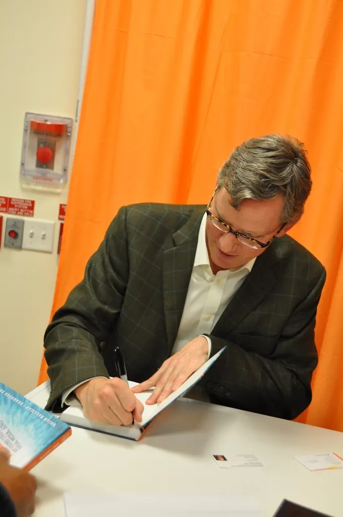 Brian Halligan signing a book (Flickr via Openverse, by-sa 2.0, credit: jameskm03)