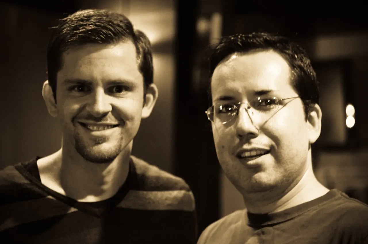 Sepia two-shot; Guillebeau left with goatee, friend with glasses