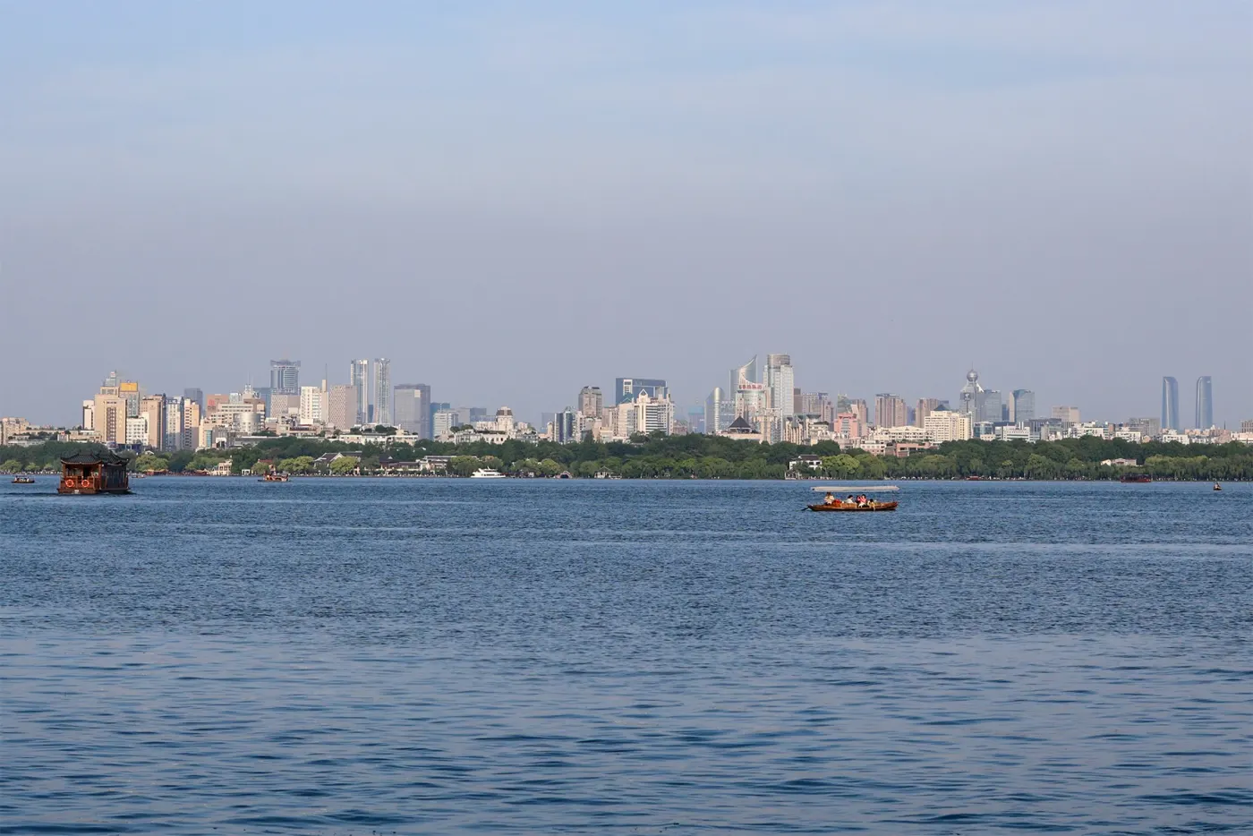 West Lake and the Hangzhou skyline, Colin's hometown (Wikimedia Commons, credit needed)