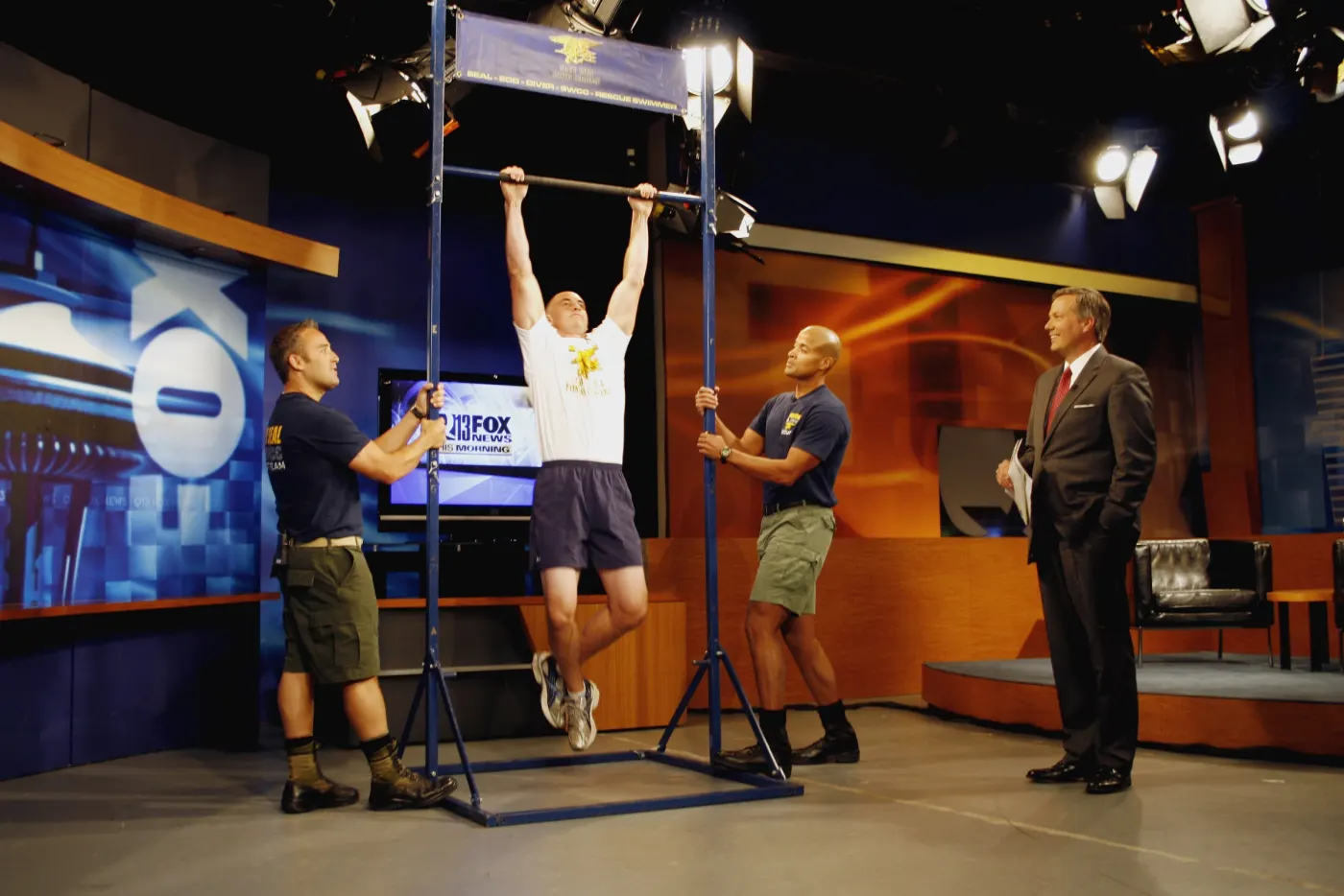 Goggins on a pull-up bar in a television studio during a record attempt