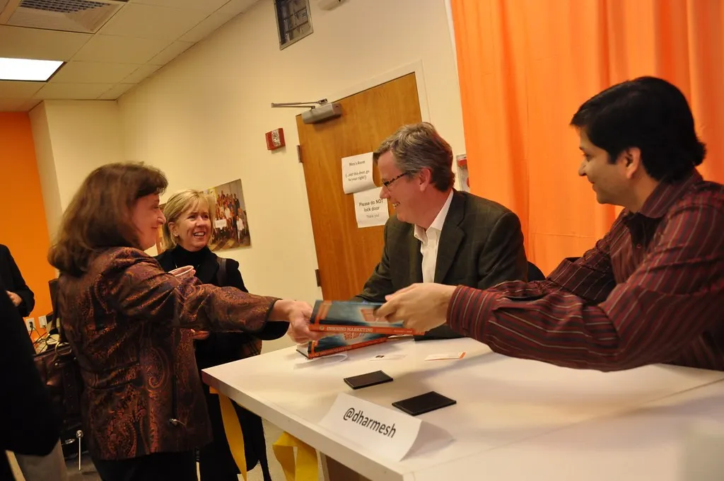 Brian Halligan and Dharmesh Shah signing copies (Flickr via Openverse, License: by-sa 2.0, credit: jameskm03)