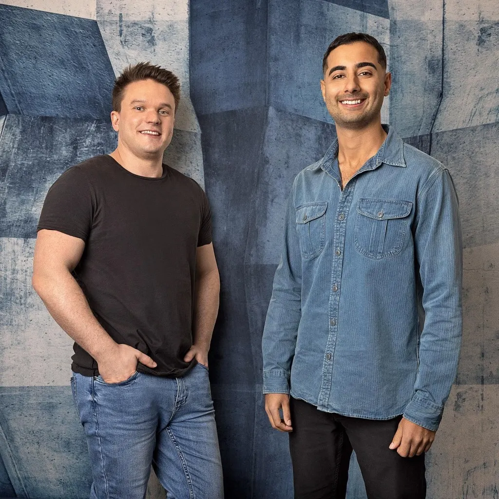 Full-length Craven and Tehrani on blue geometric set