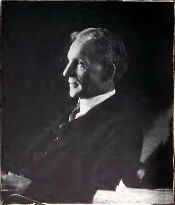 Side profile portrait of Ford in a dark suit, looking to the left (no car in frame)