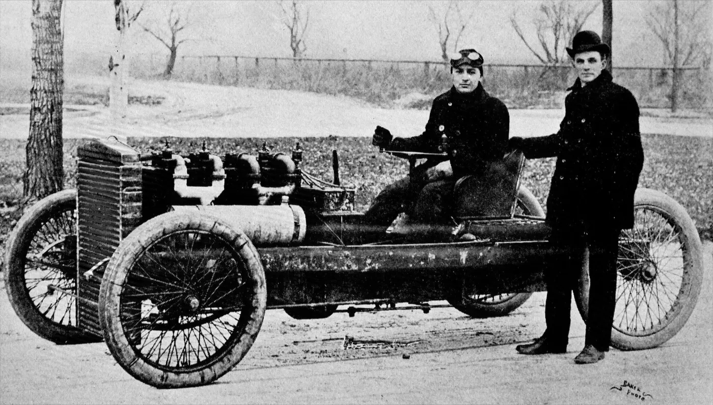 Ford standing beside the 999 race car with driver Barney Oldfield at the wheel