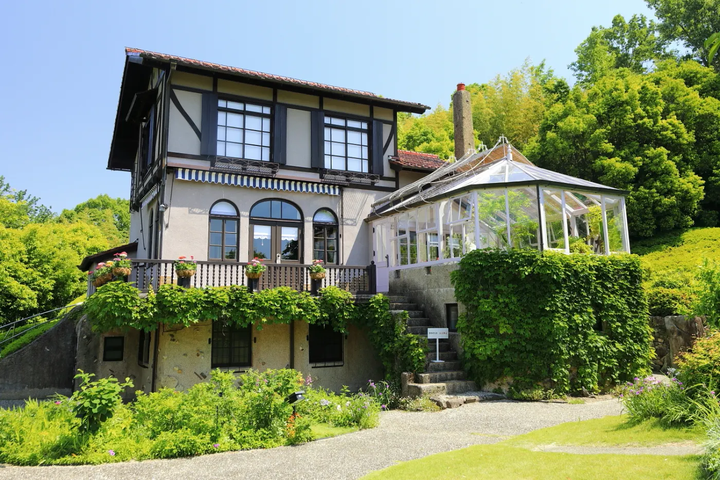 The residence with gardens and a glass sunroom