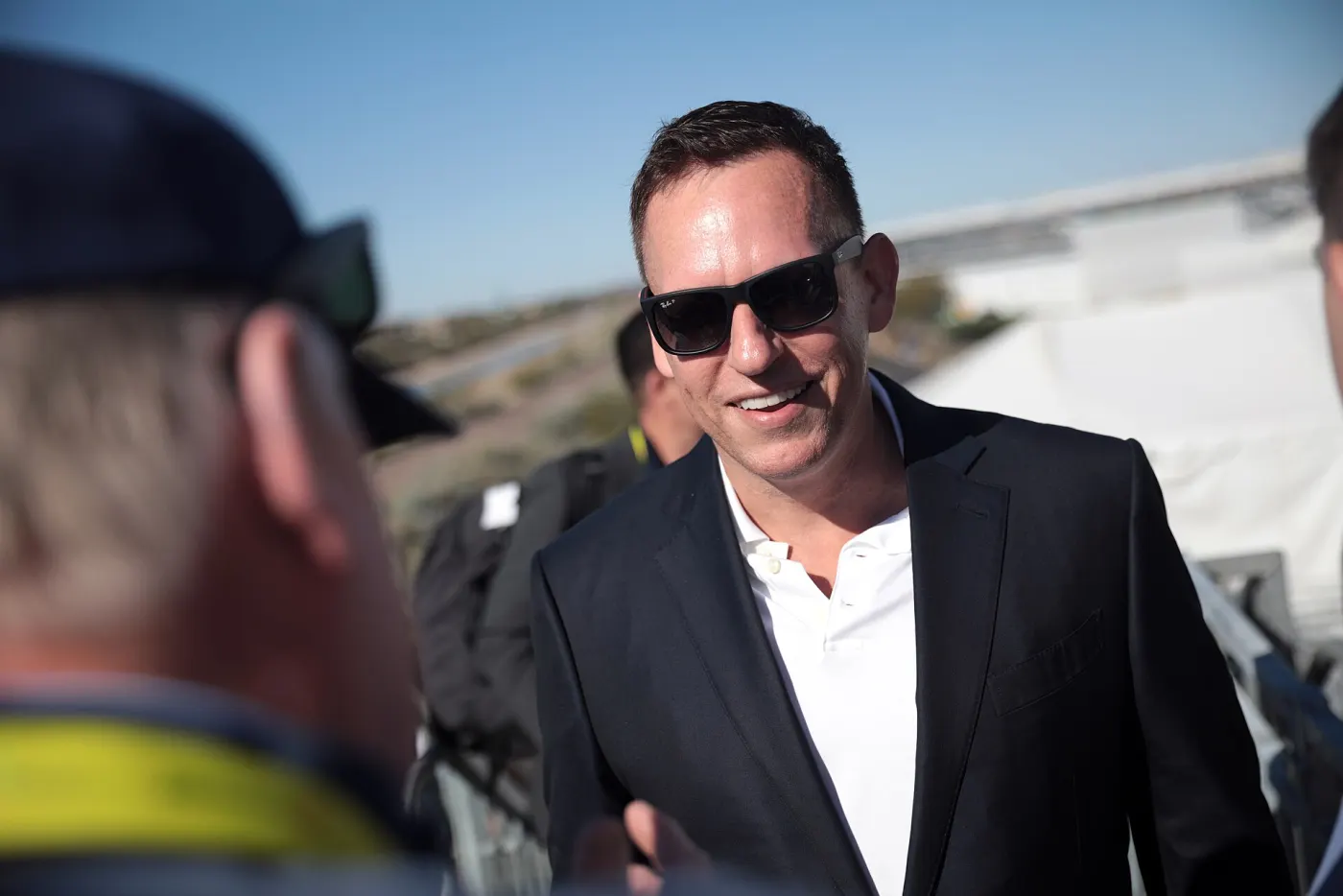 Peter Thiel outdoors in sunglasses at an event