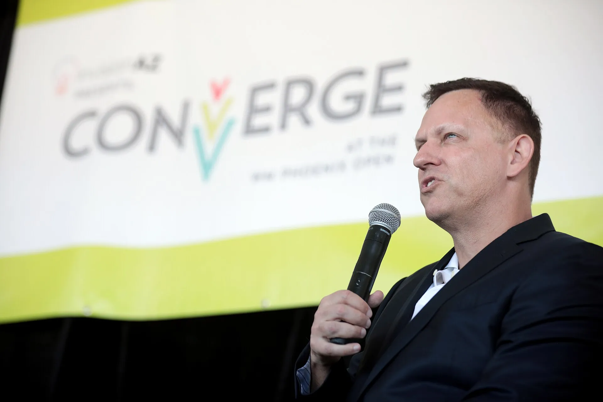Peter Thiel speaking with microphone at Converge event