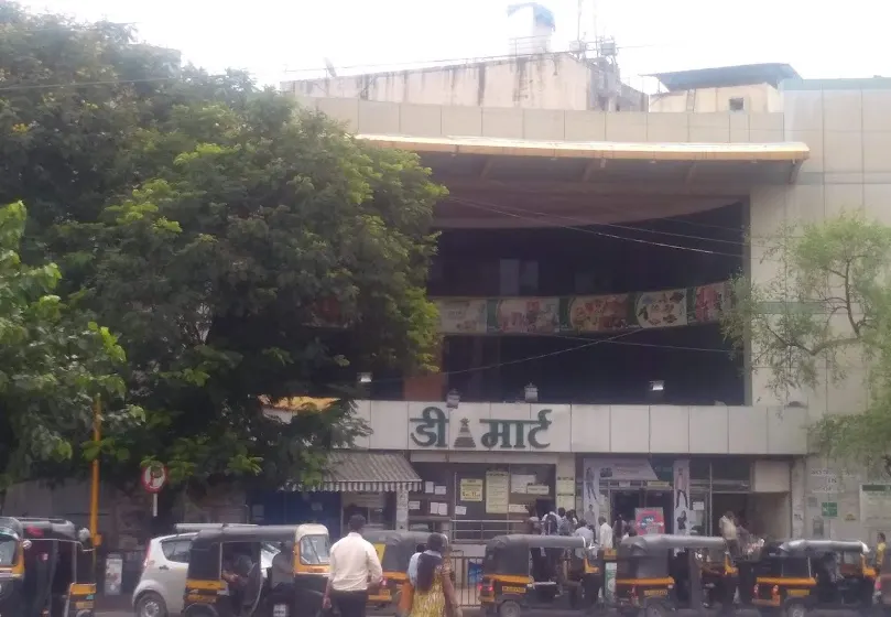 DMart storefront with Devanagari signage and street rickshaws
