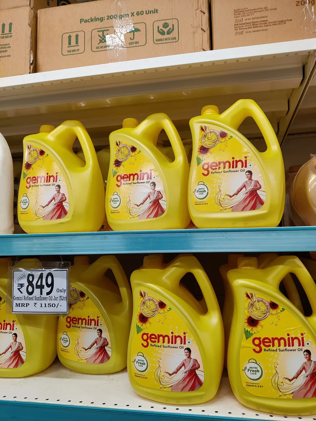 Close shelf tags showing Gemini oil MRP versus DMart price