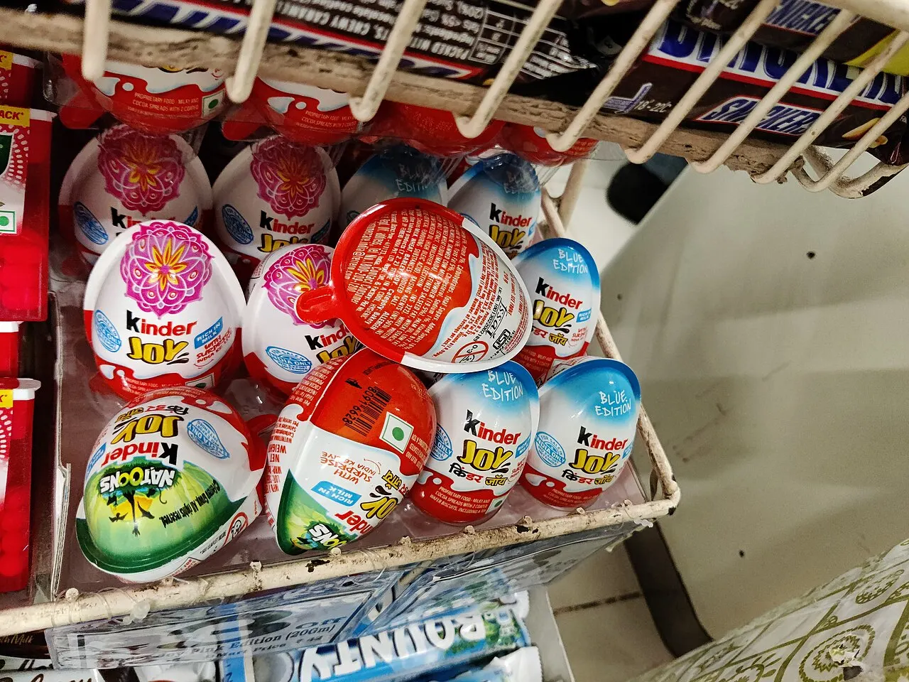 Kinder Joy and confectionery display in a supermarket aisle