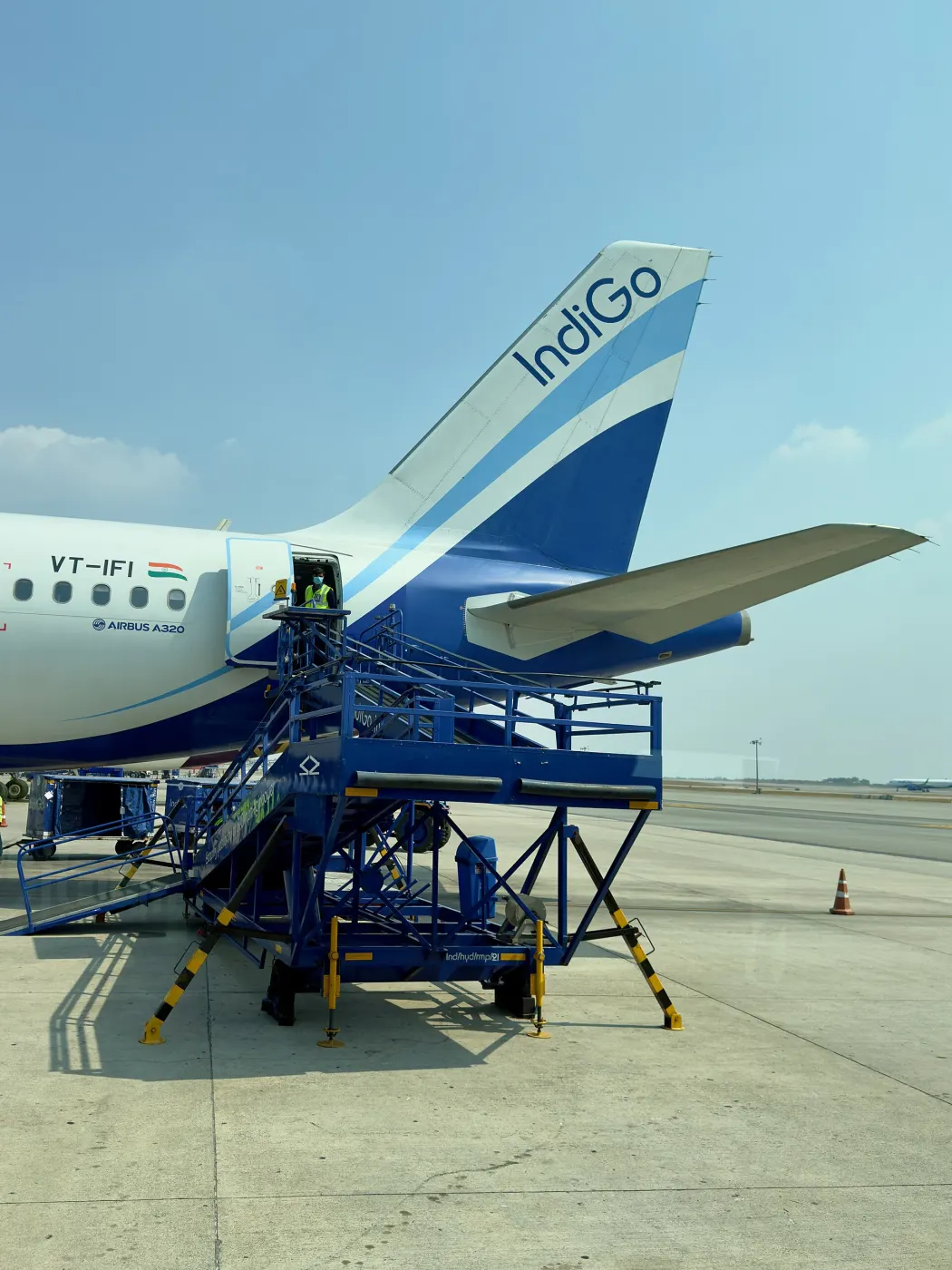 IndiGo A320 on stand with boarding stairs