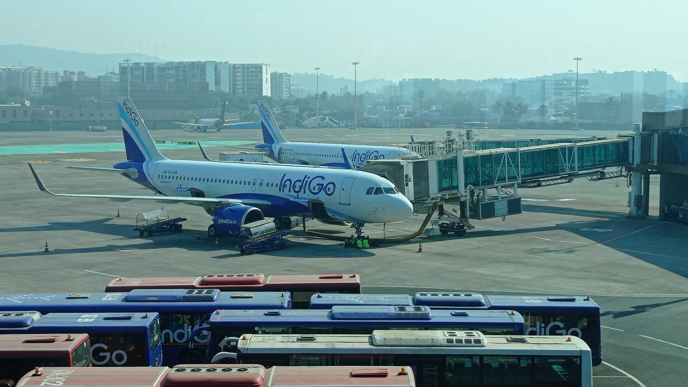 IndiGo aircraft and buses on a busy apron