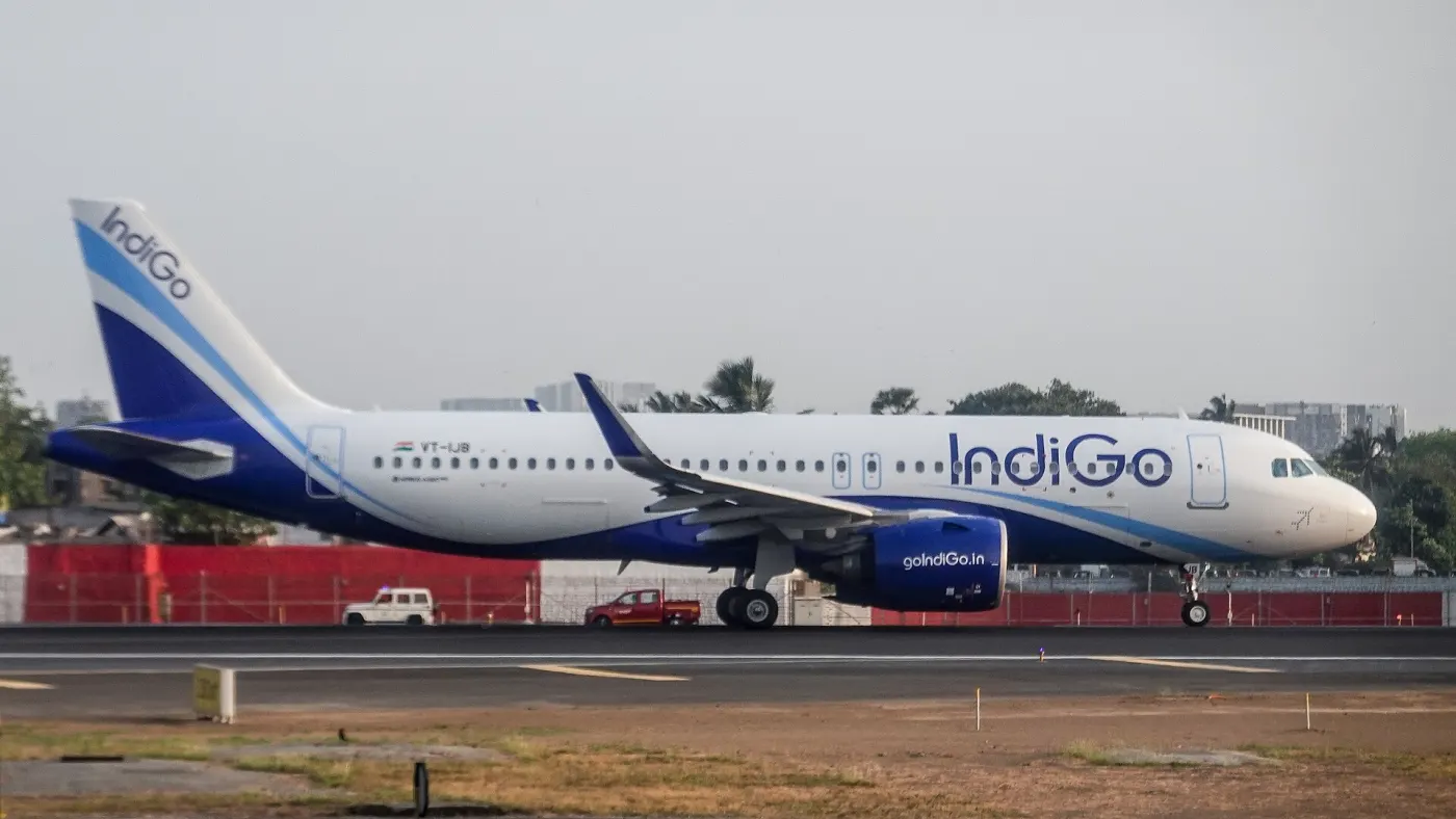 IndiGo jet on apron with ground vehicles