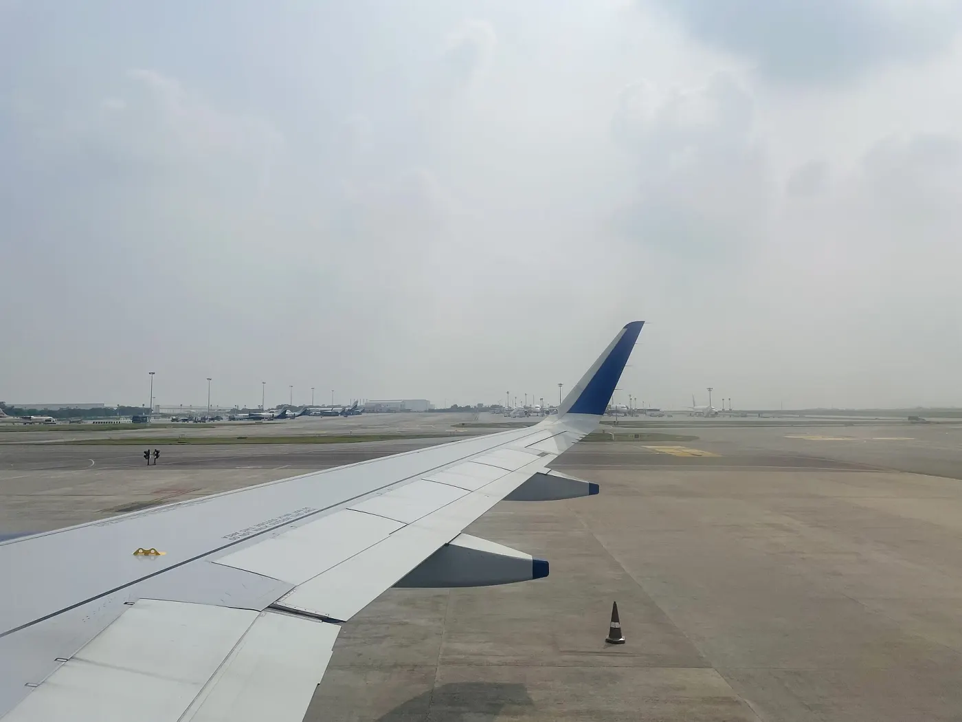 View over IndiGo-style blue winglet on taxiway