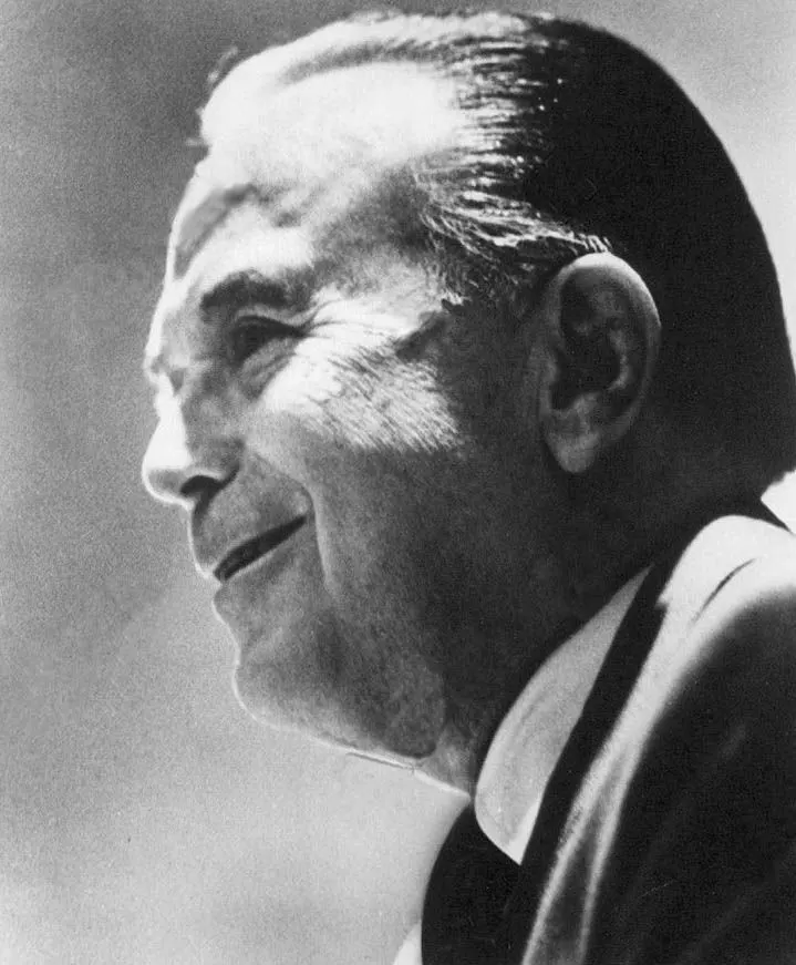 Black-and-white profile portrait of Ray Kroc, smiling