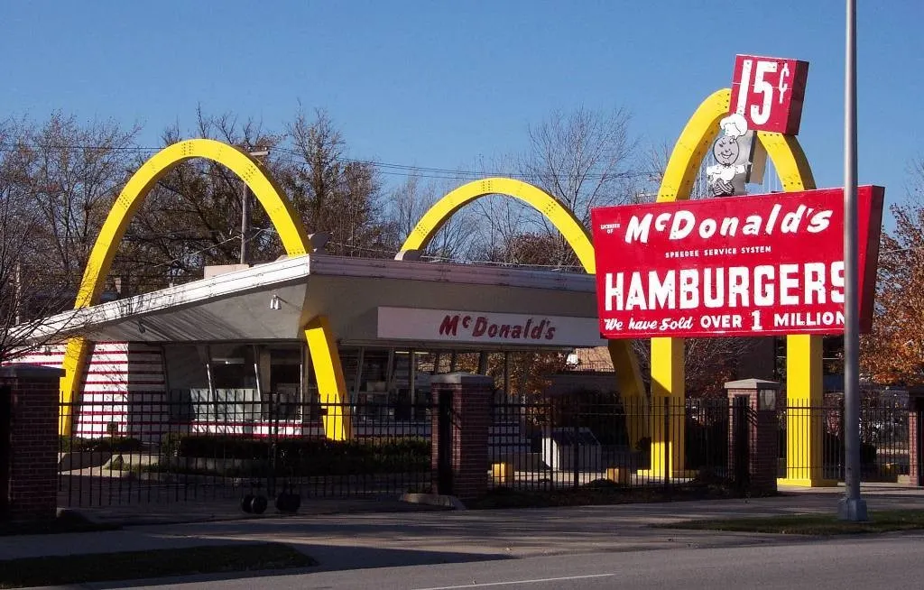 Retro McDonald's with golden arches and a 15 cent Hamburgers sign