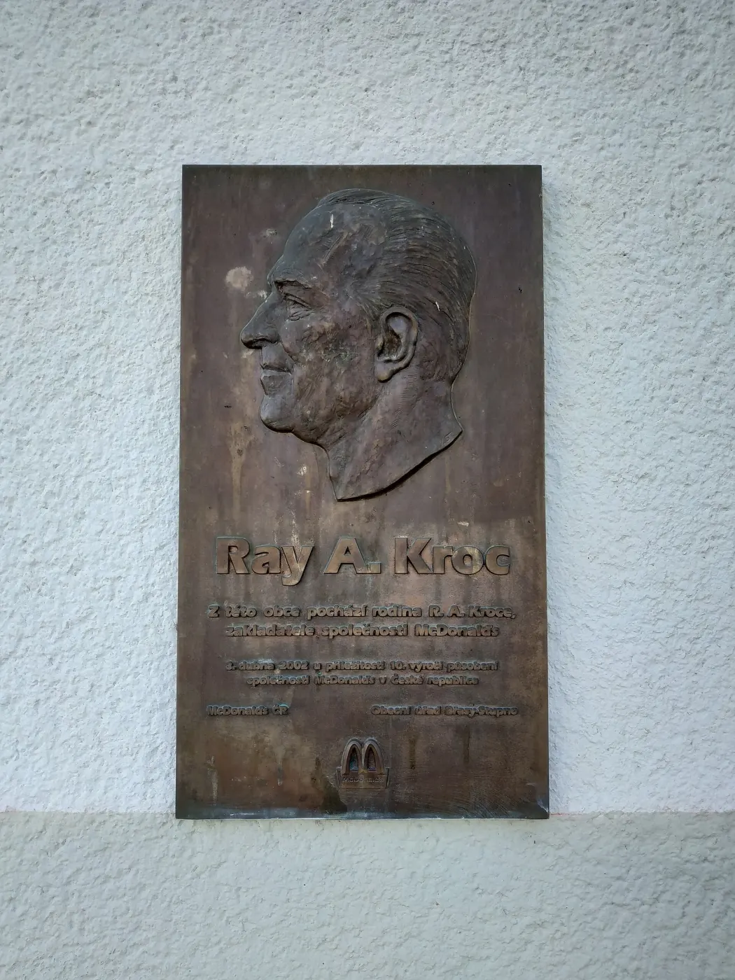 Bronze plaque with a relief portrait of Ray A. Kroc