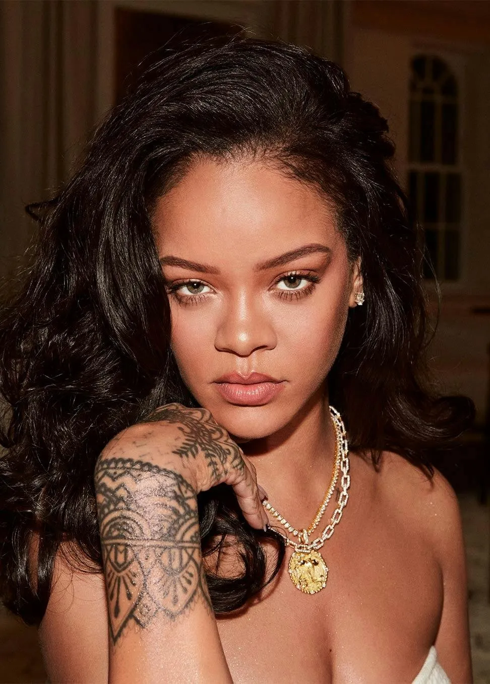 Close portrait, curls, tattooed hand near chin