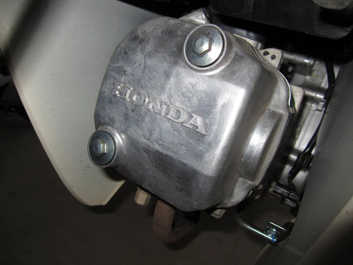 Close-up of a polished Honda engine cover with the Honda name cast into the metal