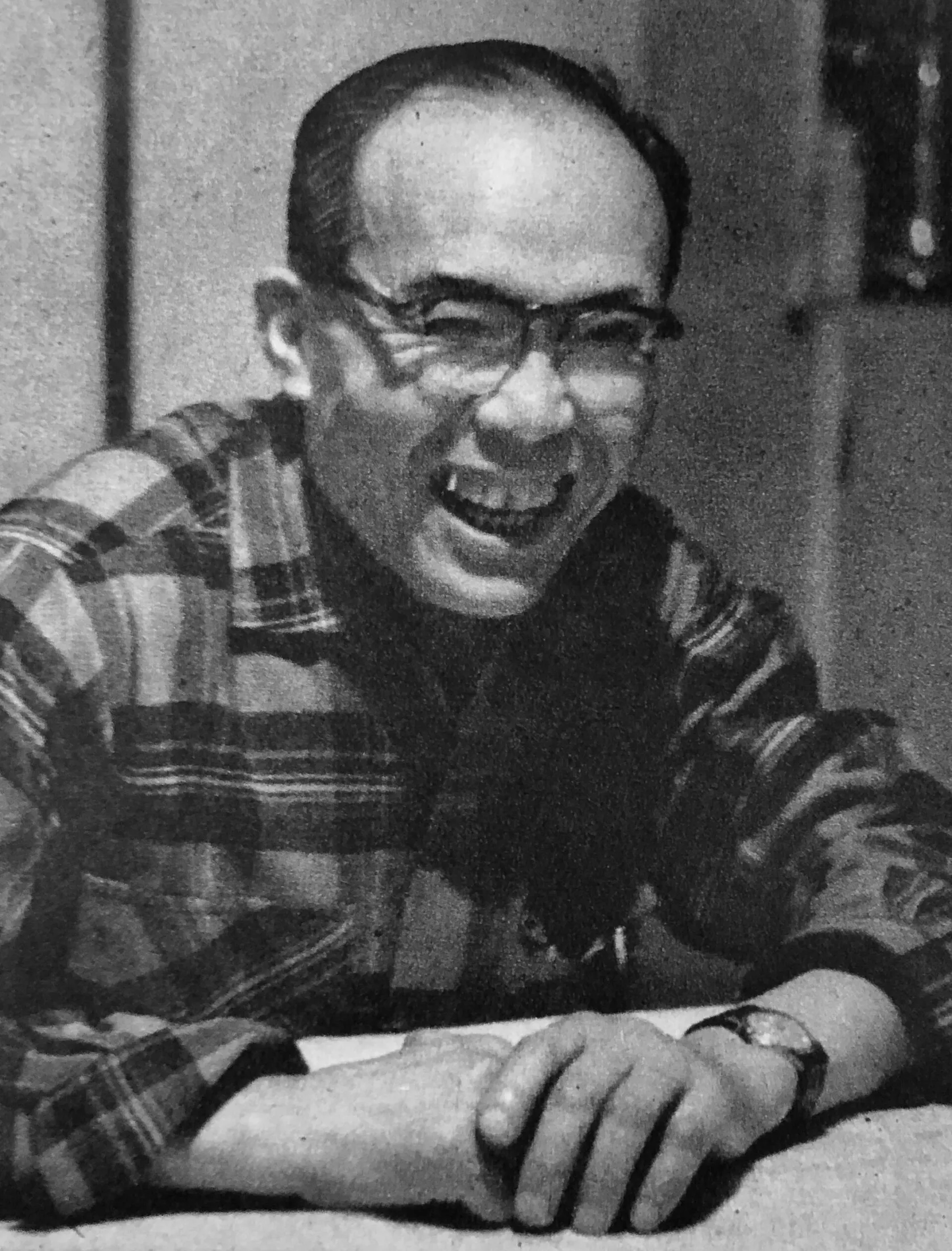 Soichiro Honda laughing, in glasses and a plaid shirt, 1955