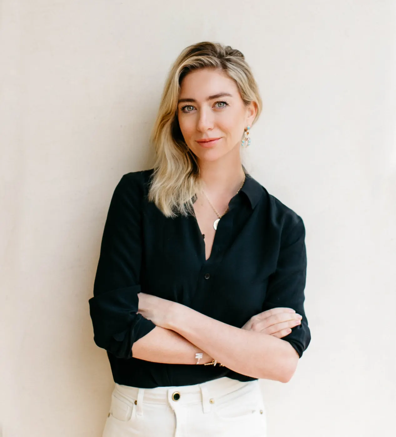 Standing portrait, dark shirt, arms crossed